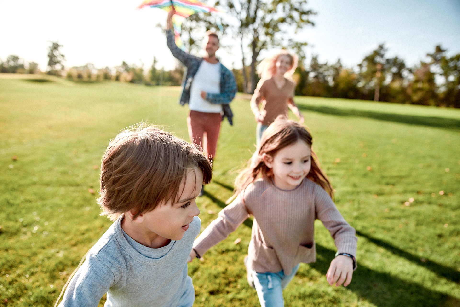 Children are living jewels. Happy family playing a kite. Outdoor