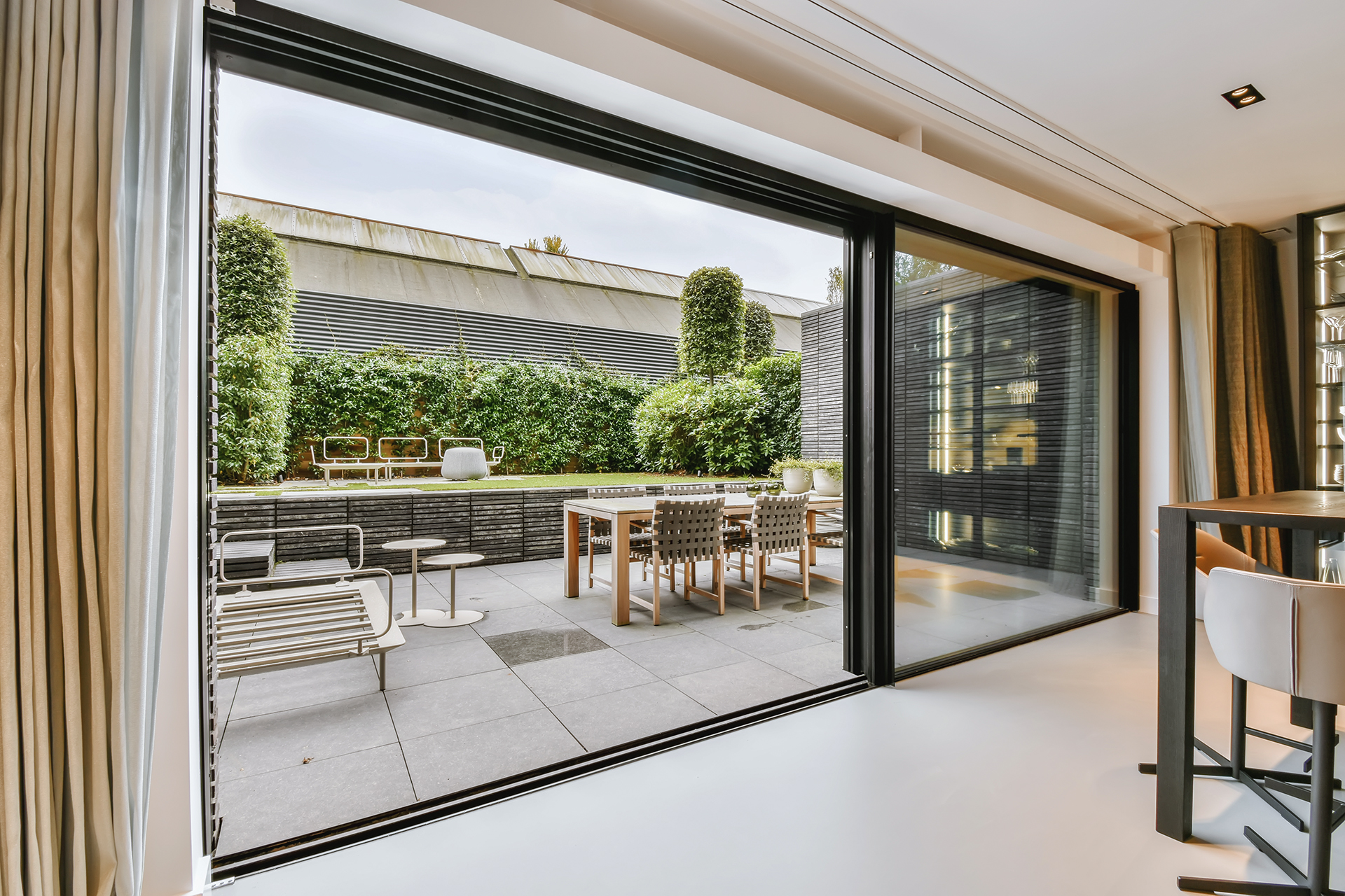 Attractive huge sliding glass door leading to the courtyard